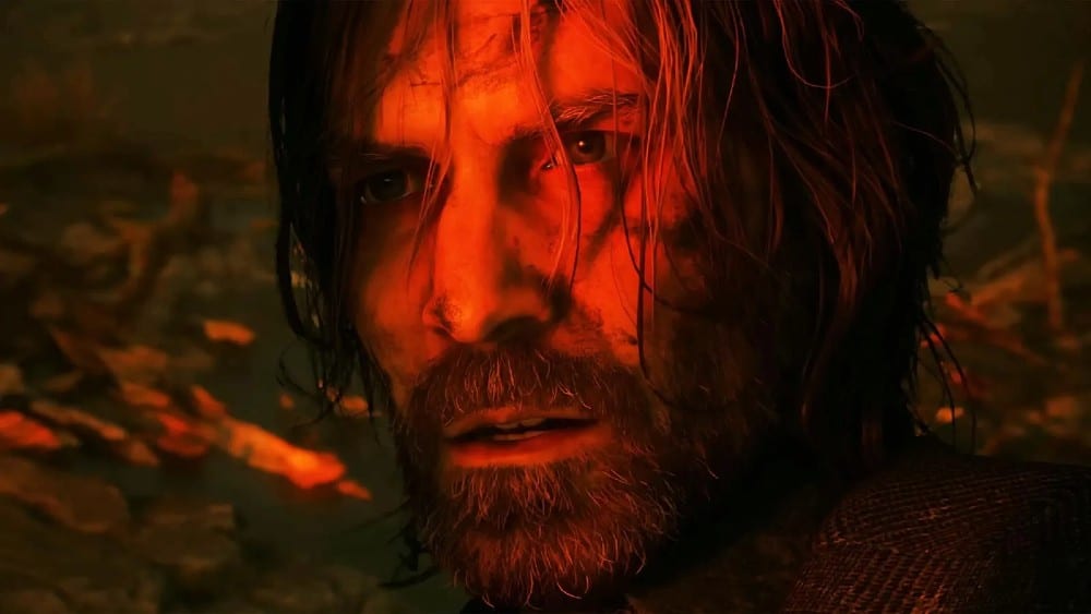 A close-up of a rugged man with long hair and a beard, illuminated by a red light, looking intense from the video game Alan Wake 2.