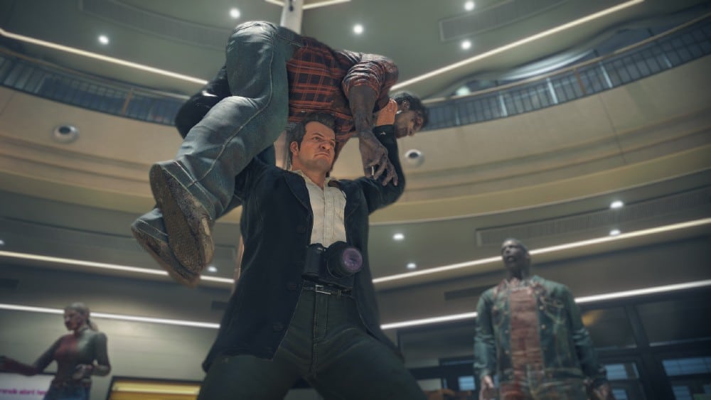 Frank West lifts a zombie over his head in a mall with zombies surrounding him, reminiscent of a scene from Dead Rising Deluxe Remaster.