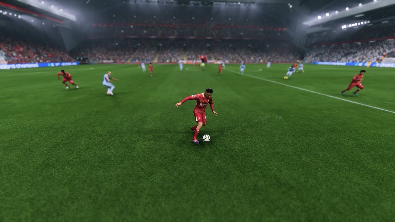 A soccer player in red dribbles the ball on a wet field, with other players and a full stadium in the background, from of an intense matchday scene in EA Sports FC 25.