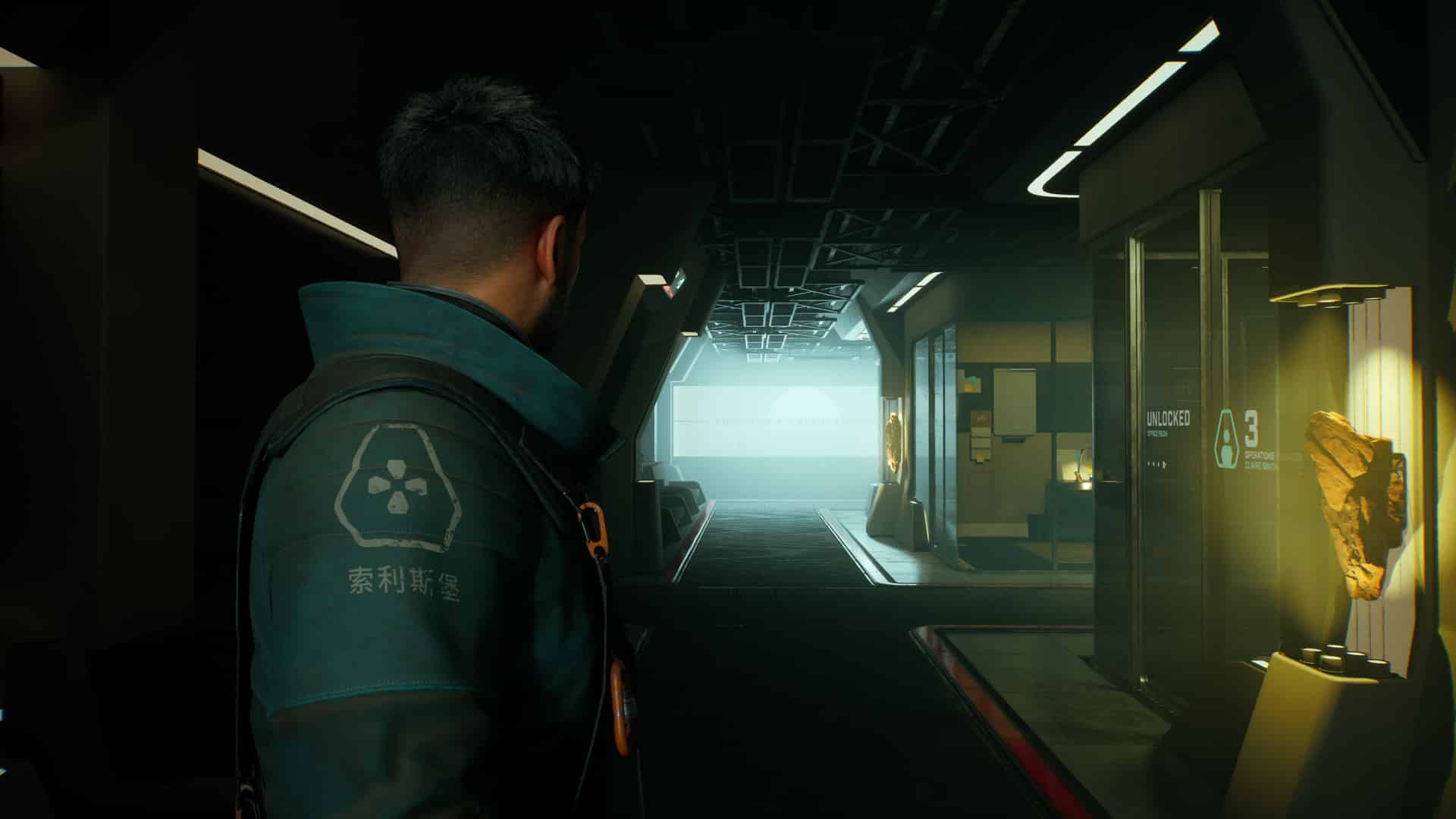 A person facing away in a dimly lit futuristic hallway, with doors and illuminated signs on either side, from the eerie corridors of Fort Solis.