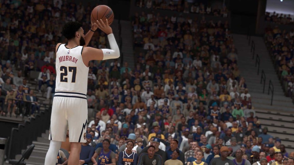 A basketball player in a white uniform with the name "Murray" and number 27 shoots a ball in front of a crowded stadium, reminiscent of an intense match in NBA 2K25.