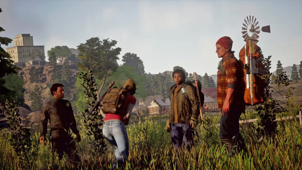 State of Decay 2 Capture - Four individuals in outdoor gear stand together in a grassy field, with a rural background. Possibly engaging in conversation about the upcoming final update for State of Decay 2.