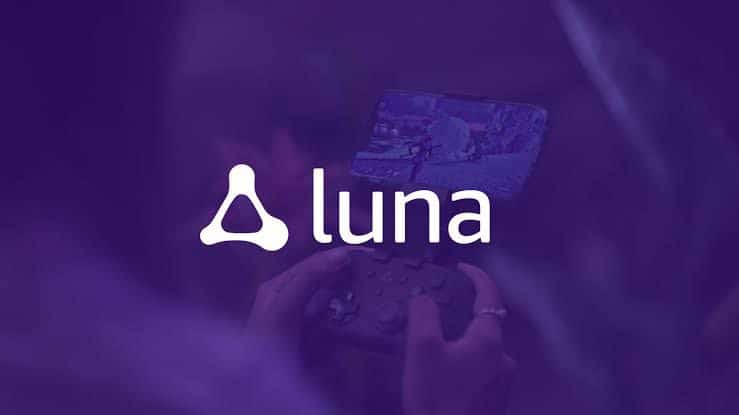 Amazon Luna logo with a white triangular symbol and the word 'Luna' in white, set against a purple background. In the blurred background, a person is holding a gaming controller and playing a game on a screen.