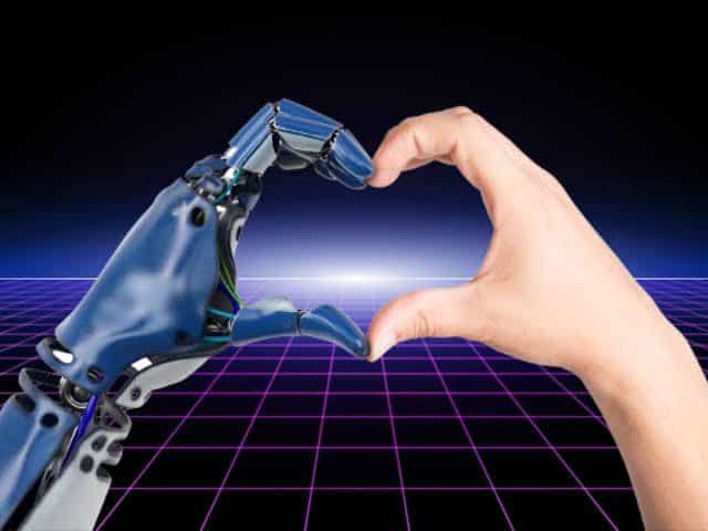 Human hand and robotic AI hand coming together to form a heart shape, symbolizing unity between humans and technology.