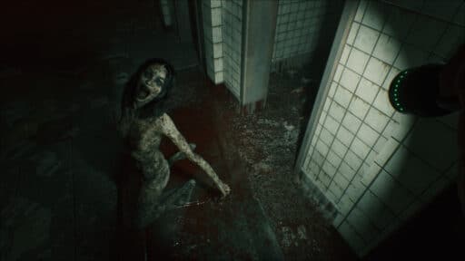 A scene from Beyond Hanwell where a terrifying, zombie-like creature kneels on a blood-stained floor in a dim, abandoned, tiled hallway—straight out of the scariest games to play this Halloween.