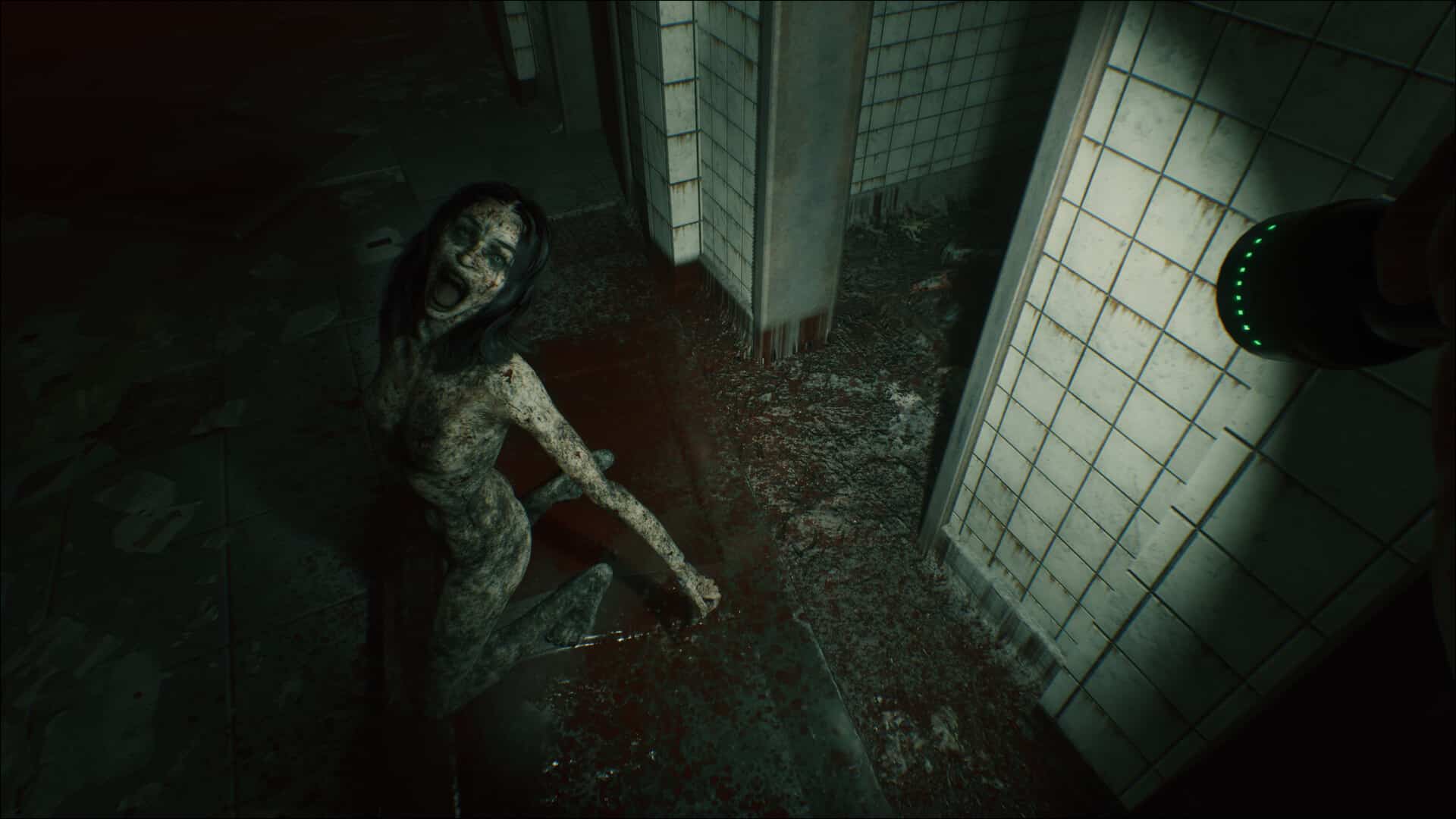 A scene from Beyond Hanwell where a terrifying, zombie-like creature kneels on a blood-stained floor in a dim, abandoned, tiled hallway—straight out of the scariest games to play this Halloween.