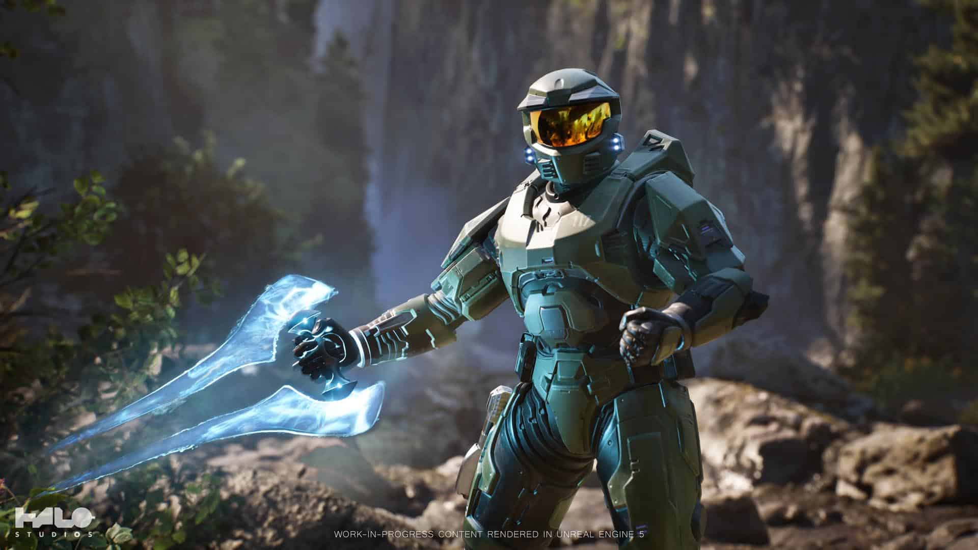 Master Chief holding an energy sword stands in a forested area with a rocky backdrop in a scene from Project Foundry.