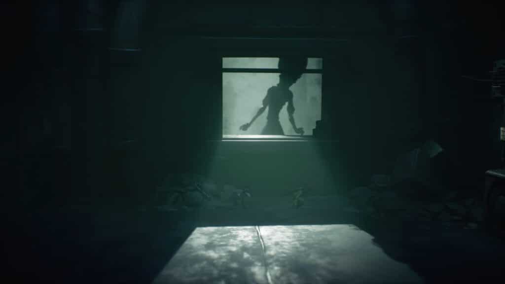 A large shadowy figure looms through a window, casting light into a dark, eerie room in Little Nightmares III—like something straight out of the scariest games to play this Halloween.