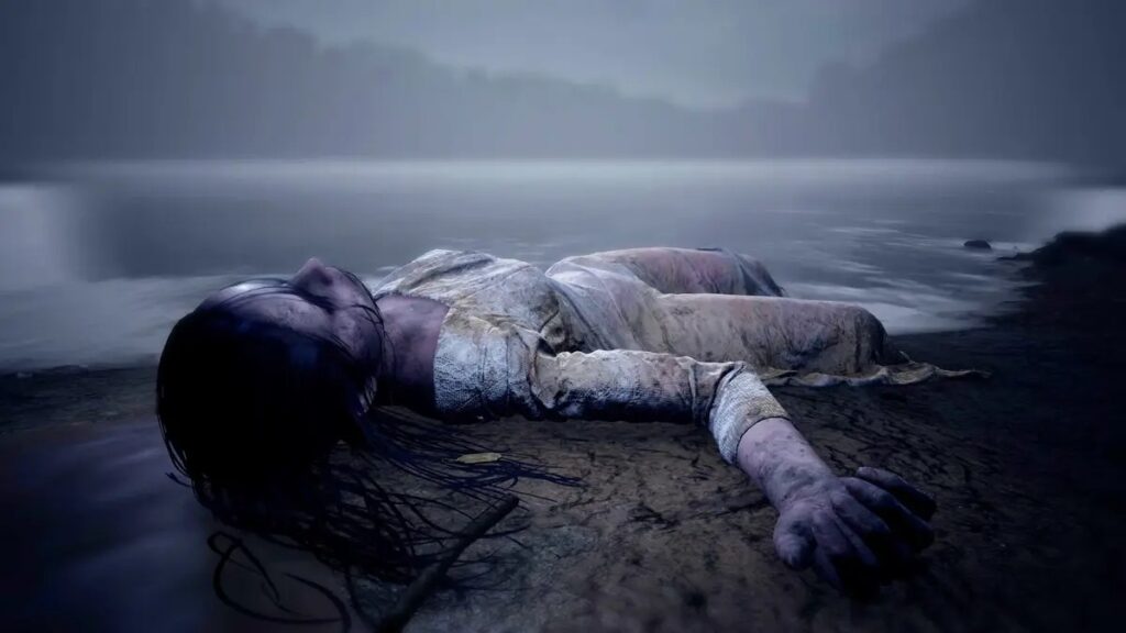 In Martha is Dead, a person in a tattered dress lies on the muddy ground near a misty body of water at dusk, evoking the eerie atmosphere of the scariest games to play.