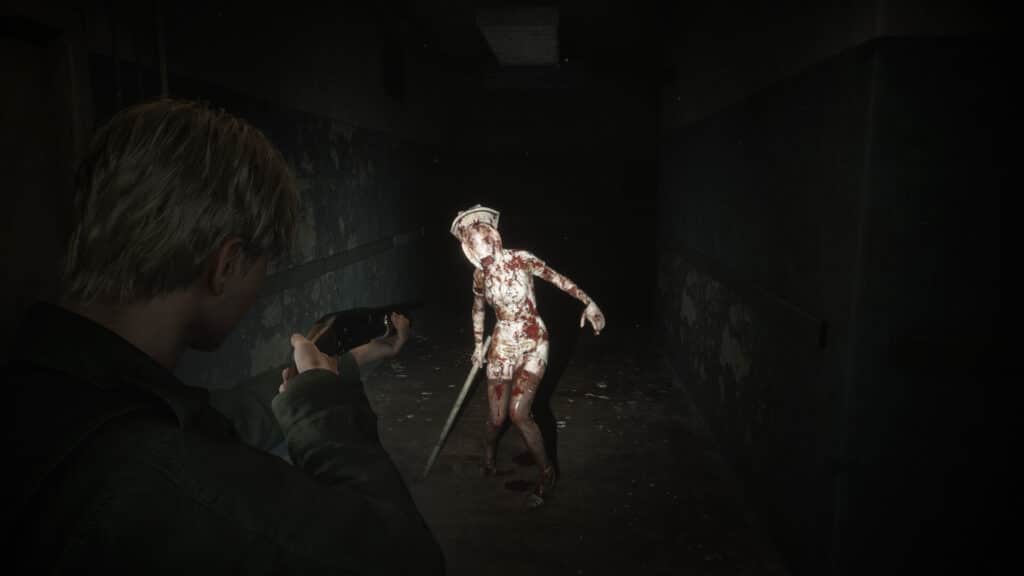 In a dark, dilapidated hallway reminiscent of Silent Hill 2 remake, a person aims a weapon at a zombie-like figure.