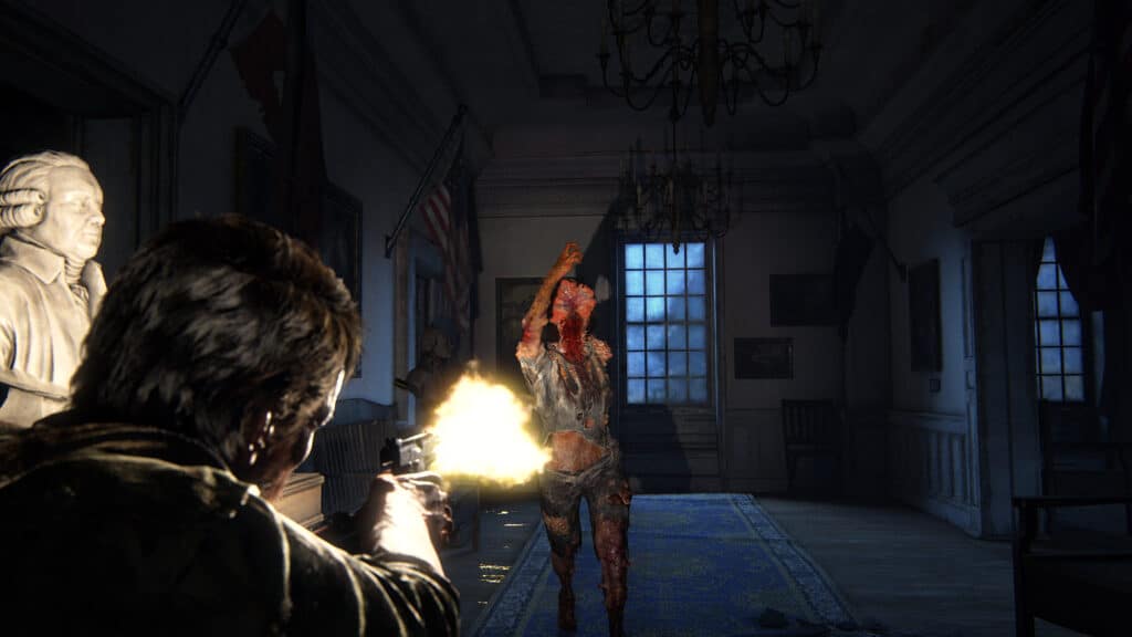 In a dimly lit, eerie hallway reminiscent of The Last of Us Part I, Joel shoots a zombie amid statues and chandeliers.