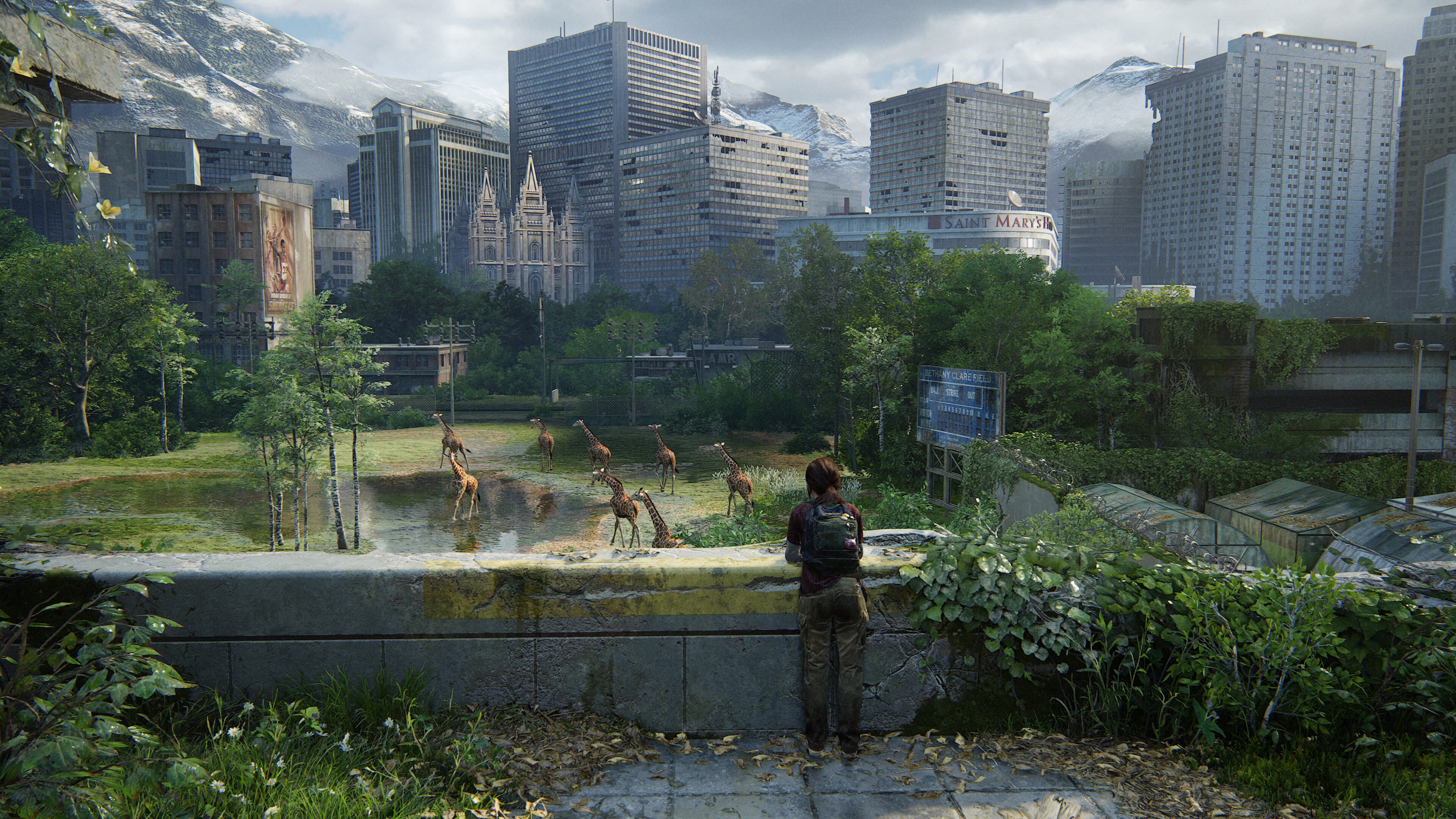 Ellie stands on an overgrown rooftop, reminiscent of The Last of Us Part I, observing giraffes in a flooded cityscape with distant skyscrapers.