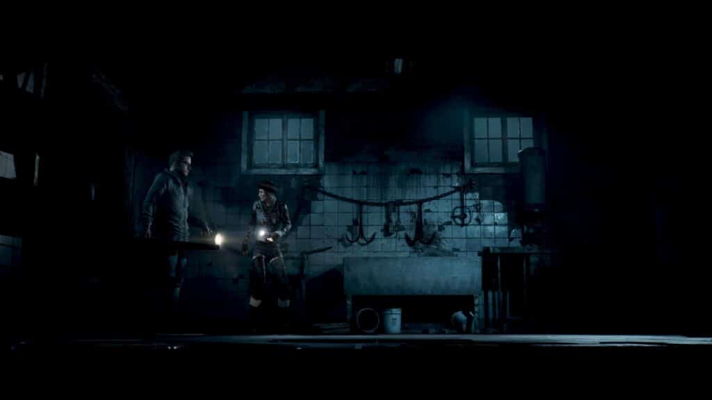 In a dimly lit basement, in a scene from Until Dawn (2024), Chris and Ashley clutch flashlights, surrounded by hanging tools and pipes.