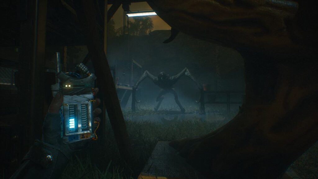 In a dark, eerie scene reminiscent of A Quiet Place: The Road Ahead, a person clutches a gadget as a spider-like creature looms ominously in the shadows.