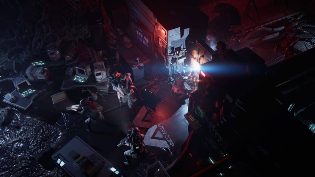 A dimly lit, futuristic lab with armed soldiers and computer equipment, illuminated by ominous red and blue lights, evokes the tense atmosphere of Aliens: Dark Descent.