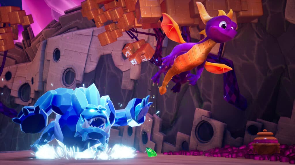 In the vibrant, rocky landscape of Spyro Reignited Trilogy, Spyro soars majestically above a shimmering blue ice creature.