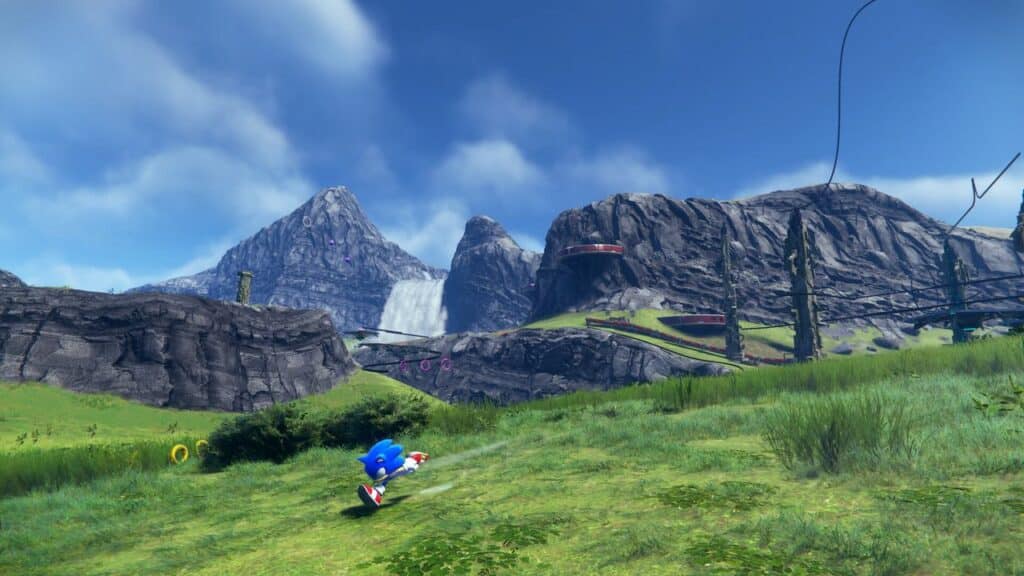 A blue hedgehog dashes through a Sonic Frontiers-inspired grassy landscape, complete with majestic mountains, a cascading waterfall, and a clear sky overhead.