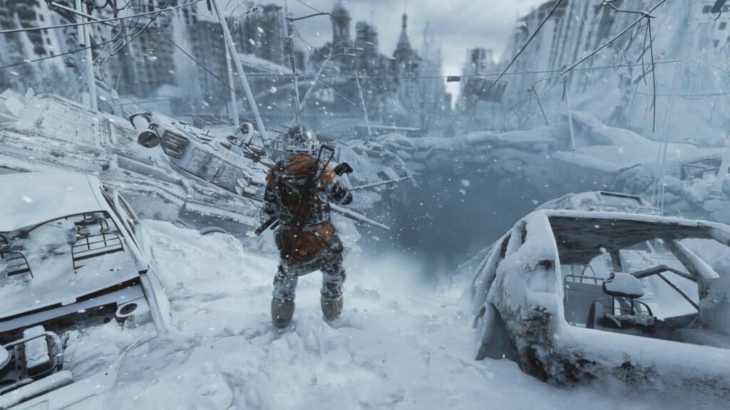 Amidst a snowy, abandoned cityscape reminiscent of Metro Exodus, a person in winter gear stands surrounded by damaged vehicles and crumbling buildings.