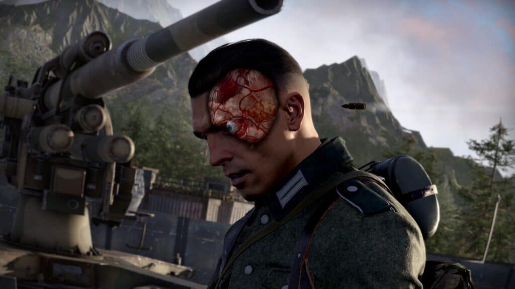 Amidst the rugged mountains, a soldier with a visible brain injury stands resolute beside a large artillery gun, embodying the resilience reminiscent of a Sniper Elite: Resistance review unfolding in the harsh terrain.