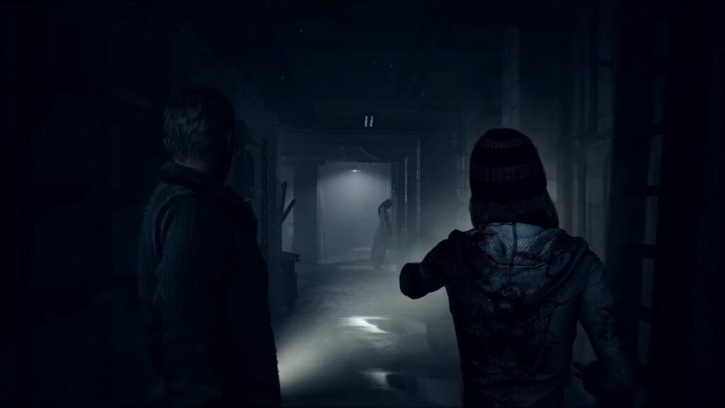 Two people shine a flashlight down a dark, misty hallway, evoking the suspense of video games to play with your girlfriend or boyfriend, where a distant figure stands in the shadows.