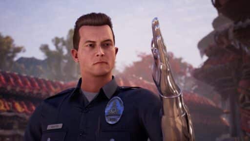 In an outdoor scene with trees and buildings, a man in a police uniform raises a metallic prosthetic arm, reminiscent of a character from the Mortal Kombat 1: Khaos Reigns trailer.