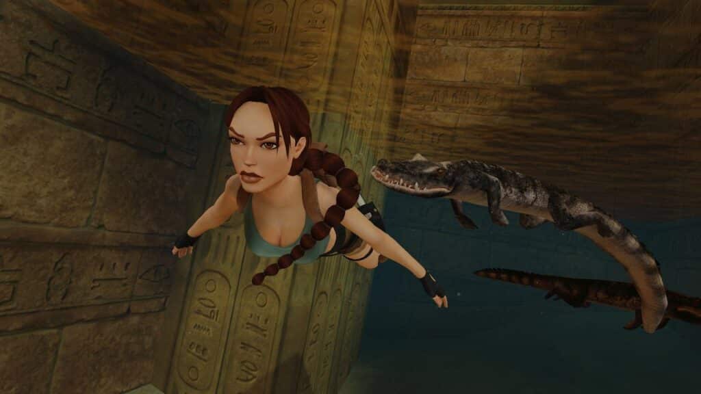 In an adventure reminiscent of Tomb Raider IV-VI Remastered, a woman gracefully swims through ancient ruins, gliding past mysterious hieroglyphics with two crocodiles trailing her every move.