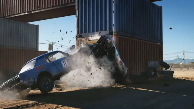 A blue car crashes into shipping containers with debris flying, set in an industrial area under a clear sky.