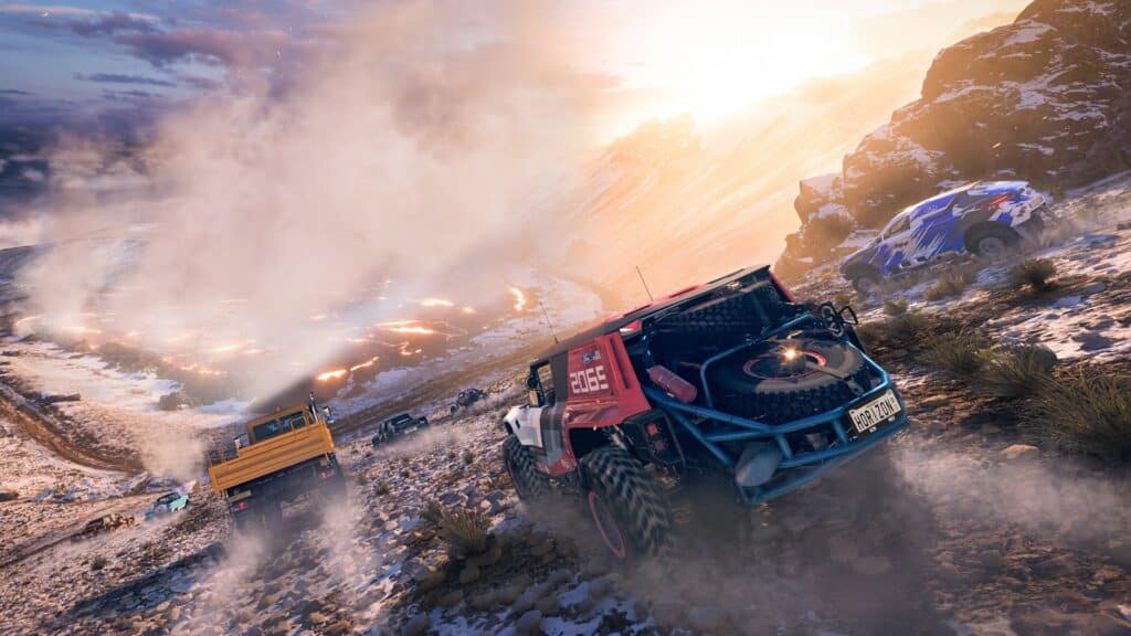 Off-road vehicles race down a rocky, snowy hill at sunrise in Forza Horizon 5 PS5, kicking up dust and dirt.