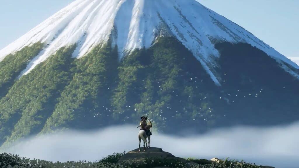 A person on horseback stands on a hill, gazing at a large snow-capped mountain under a clear sky, as if searching for Ghost of Yōtei new details in the tranquil landscape.