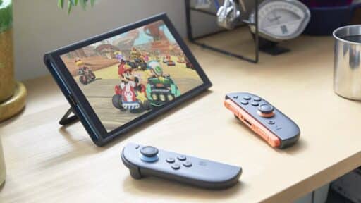 Nintendo Switch 2 with Joy-Con 2 controllers on a desk, displaying a Mario Kart World on its screen, highlights the Nintendo Switch 2 portability—perfect for gaming at home or on the go.