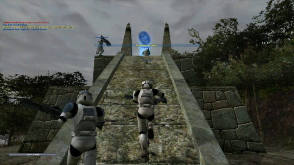 Three armored soldiers run up a stone staircase toward a glowing blue objective, capturing the excitement of the best Star Wars games to play on May the 4th.