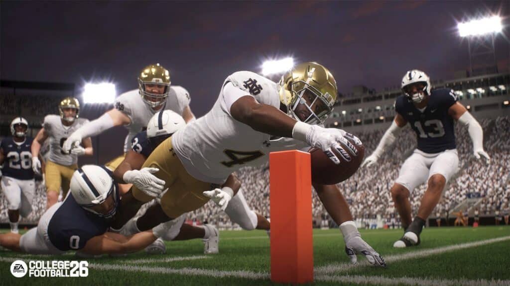 A football player dives toward the end zone, reaching the ball past the pylon as defenders try to stop him—just like a dramatic moment in the College Football 26 trailer.