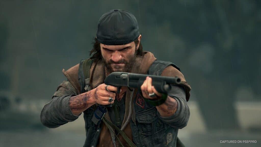A bearded man in rugged clothing aims a shotgun forward in the rain, looking intense and focused—a gripping scene from Days Gone Remastered.