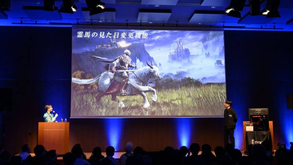 Two presenters showcase Elden Ring Tarnished Edition, featuring a knight on horseback, on a large screen to an eager audience—now coming to Nintendo Switch 2.
