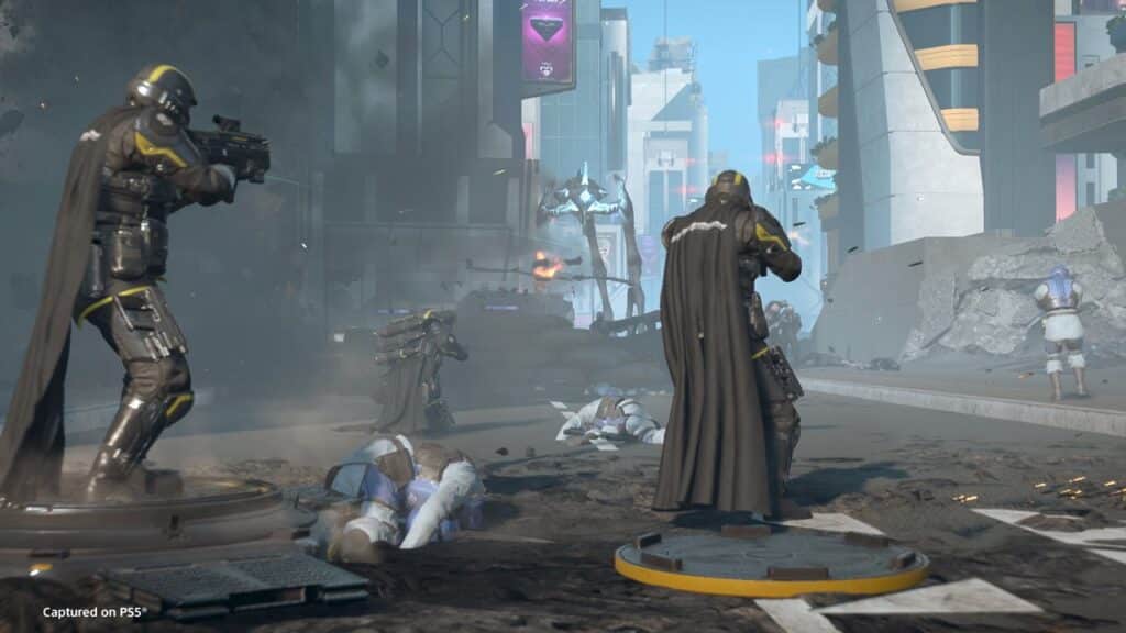 Futuristic soldiers in armor and capes, inspired by the Helldivers 2 Heart of Democracy update, fight in a city street amid fallen enemies and damaged buildings.