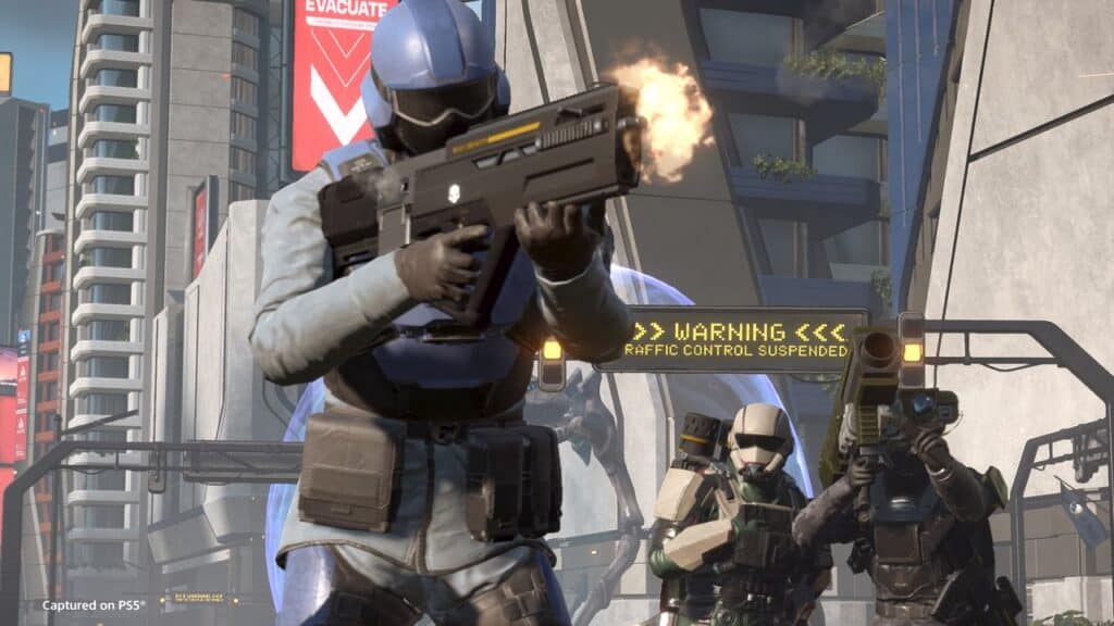 Three armored soldiers with guns battle in a futuristic city—one firing—amid warning signs in the background, inspired by the Helldivers 2 Heart of Democracy update.