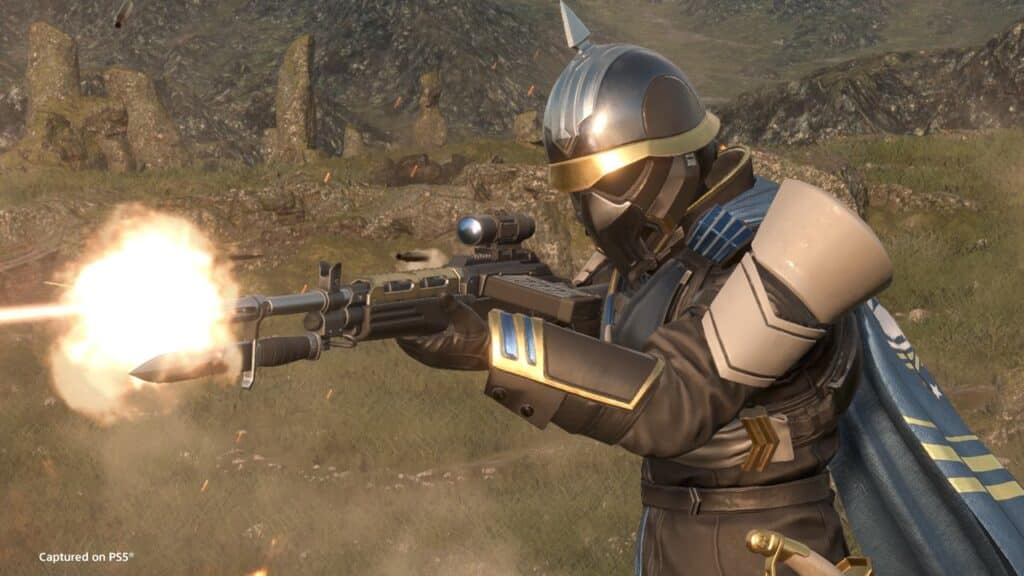 An armored Helldivers 2 warrior in a helmet fires a rifle with a bright muzzle flash, standing amid grassy, rocky terrain—ready for action in the Masters of Ceremony Warbond.
