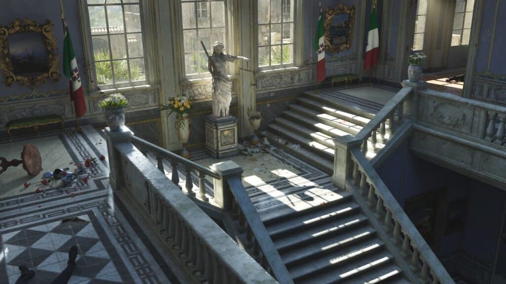 Grand staircase in a sunlit hall with a statue, plants, and Italian flags by large windows—echoing the elegance discussed at the Mafia: The Old Country PAX East panel.