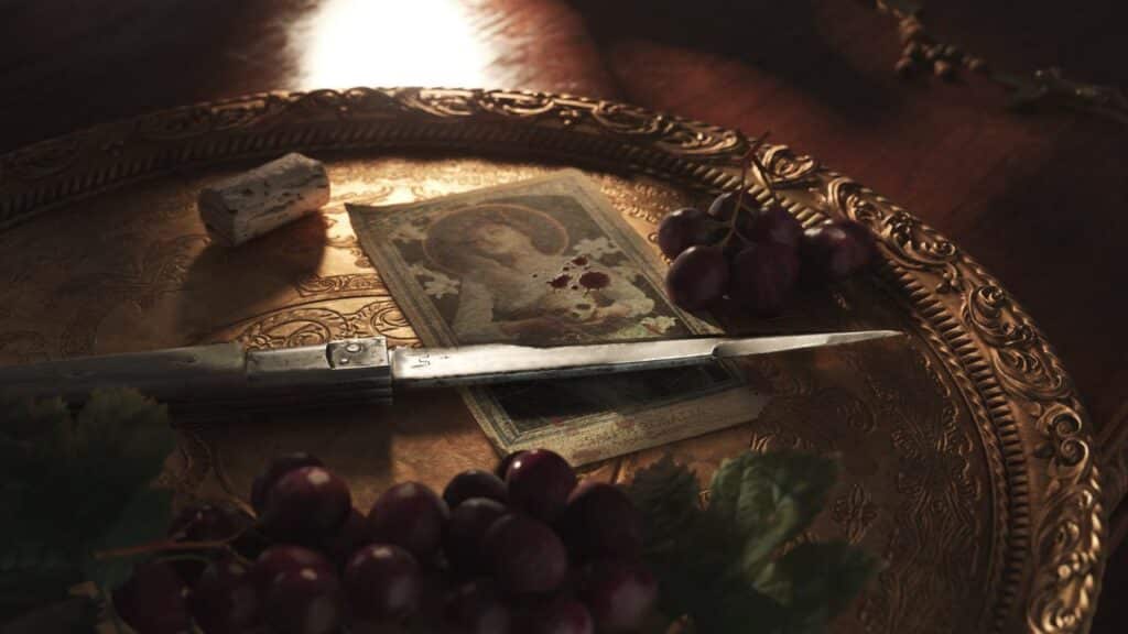 A knife, grapes, a cork, and a bloodstained portrait on an ornate golden tray—an evocative scene reminiscent of the intrigue discussed at the Mafia: The Old Country PAX East panel.