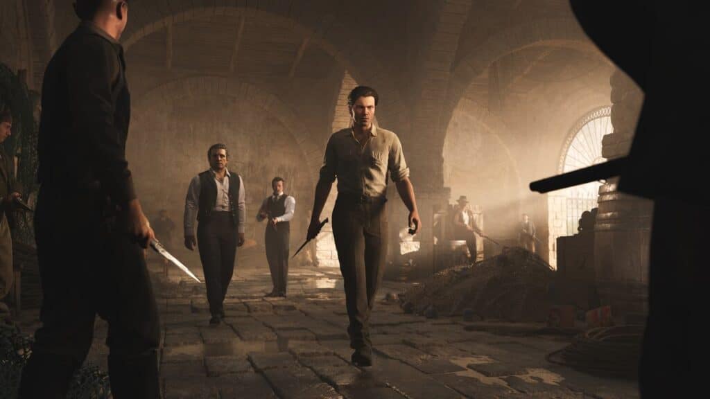 Several men from Mafia: The Old Country confront each other tensely in a dimly lit, rustic stone room, some holding weapons.