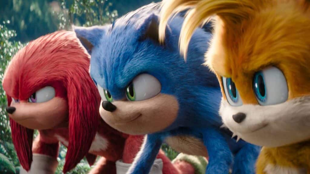 Animated characters Knuckles, Sonic, and Tails crouch together, looking determined in a forest setting—capturing the adventurous spirit highlighted in Sega financial results 2025.