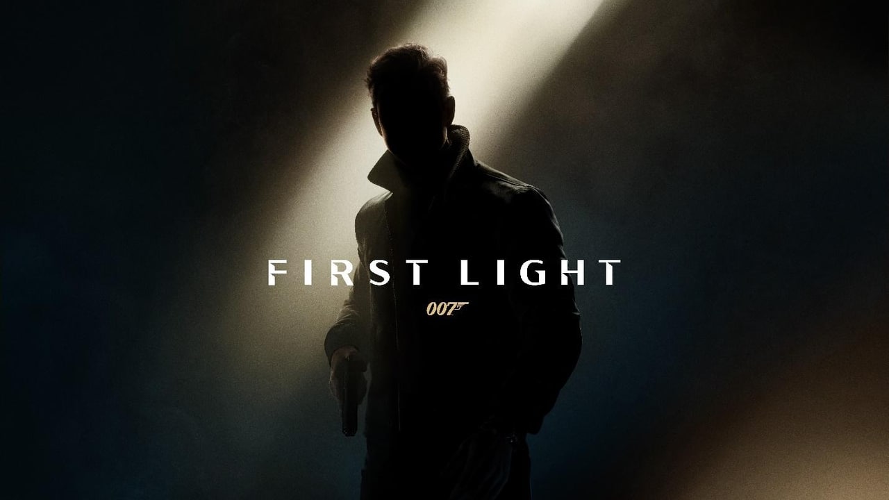 Silhouette of a man holding a gun under a spotlight, with "007 First Light" boldly displayed in the center.