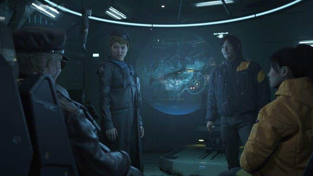 Four people in futuristic uniforms sit and stand around a glowing holographic map display in a dimly lit room, reminiscent of scenes from Death Stranding 2: On The Beach.