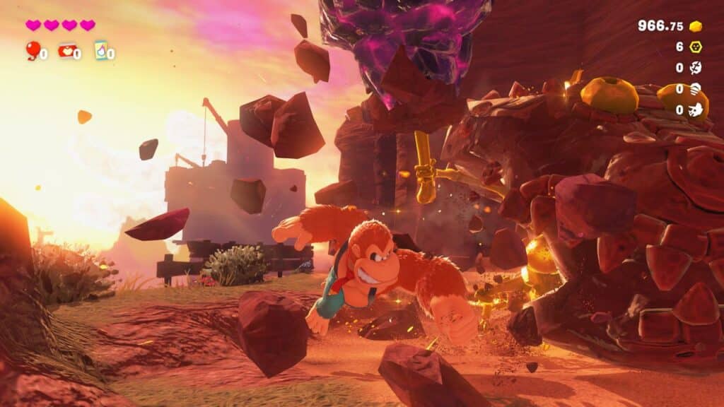 Donkey Kong darts away from a giant rock monster in a colorful, sunlit landscape during an exciting Donkey Kong Bananza Direct video game scene.
