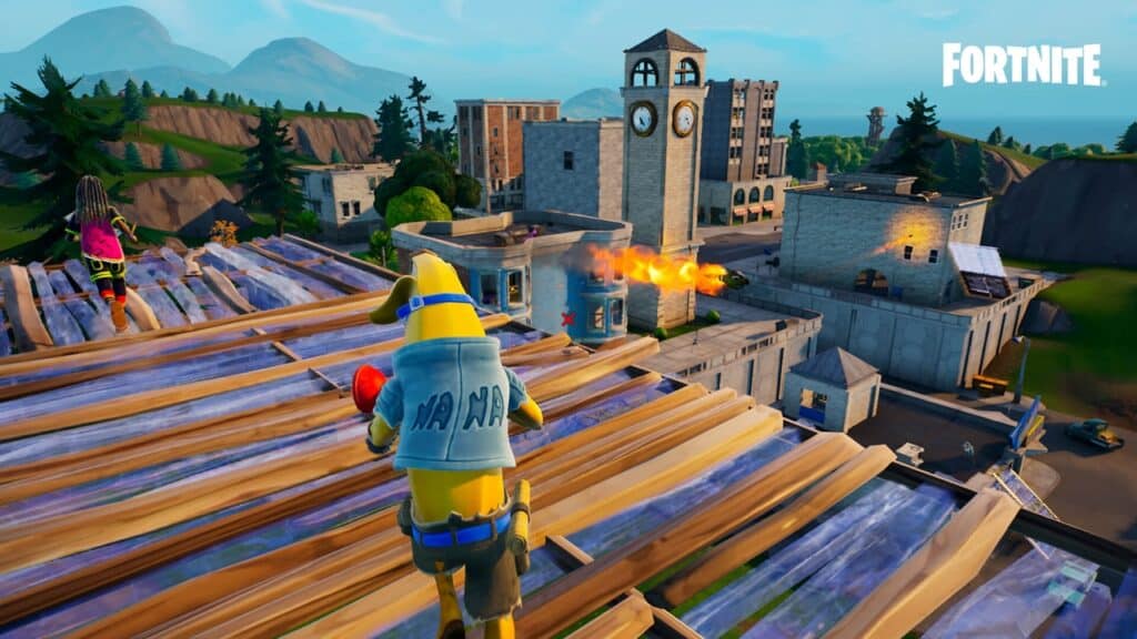 A Fortnite character in a banana suit aims at a burning building in Tilted Towers with another player nearby, ready for action on the Fortnite Nintendo Switch 2.