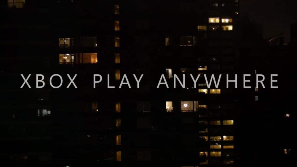 Windows of a dark building lit up at night with the text 'XBOX PLAY ANYWHERE' overlaid, hinting at the excitement for Phil Spencer Xbox 2025 announcements.