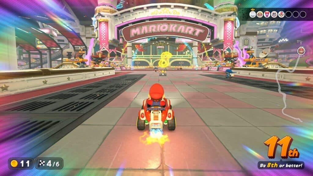 Mario speeds through a vibrant Mario Kart World track, collecting 11 coins as he races to secure 8th place or better.
