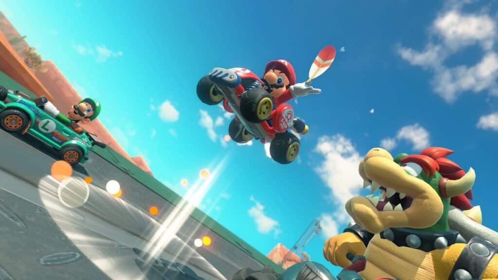 Mario jumps his kart as Luigi and Bowser race beside him on a bright, sunny track in Mario Kart World.