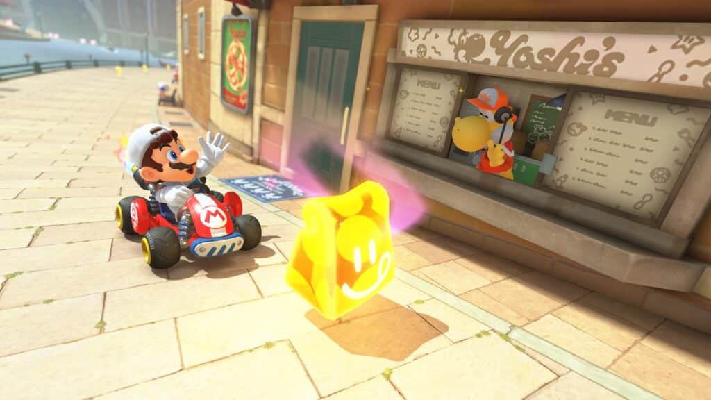 Mario Kart World comes alive as Mario waves from his go-kart at Yoshi, who's running a food stand, while a glowing yellow item sparkles on the ground nearby.