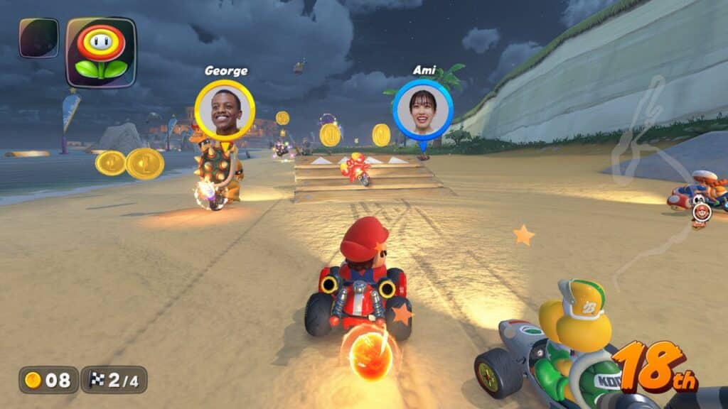 Experience a Mario Kart World race on a sun-soaked beach track, collecting coins as player names and positions are displayed on screen.